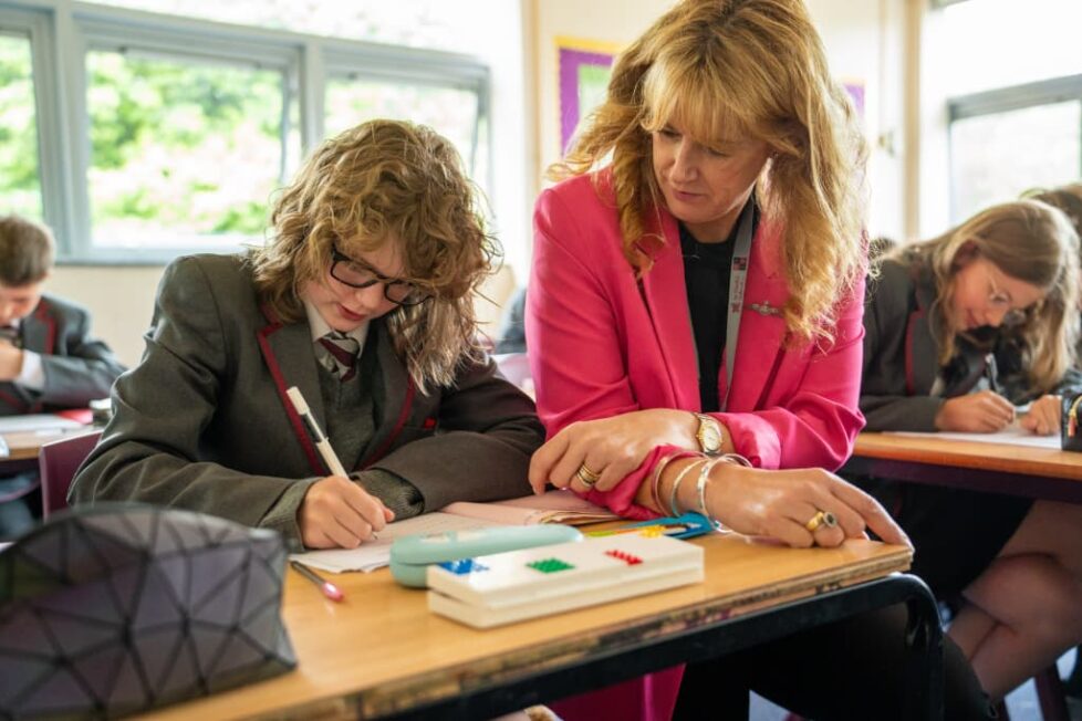 Mrs England working with a student